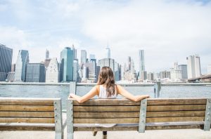 woman sitting down relaxing watching new york skyline
